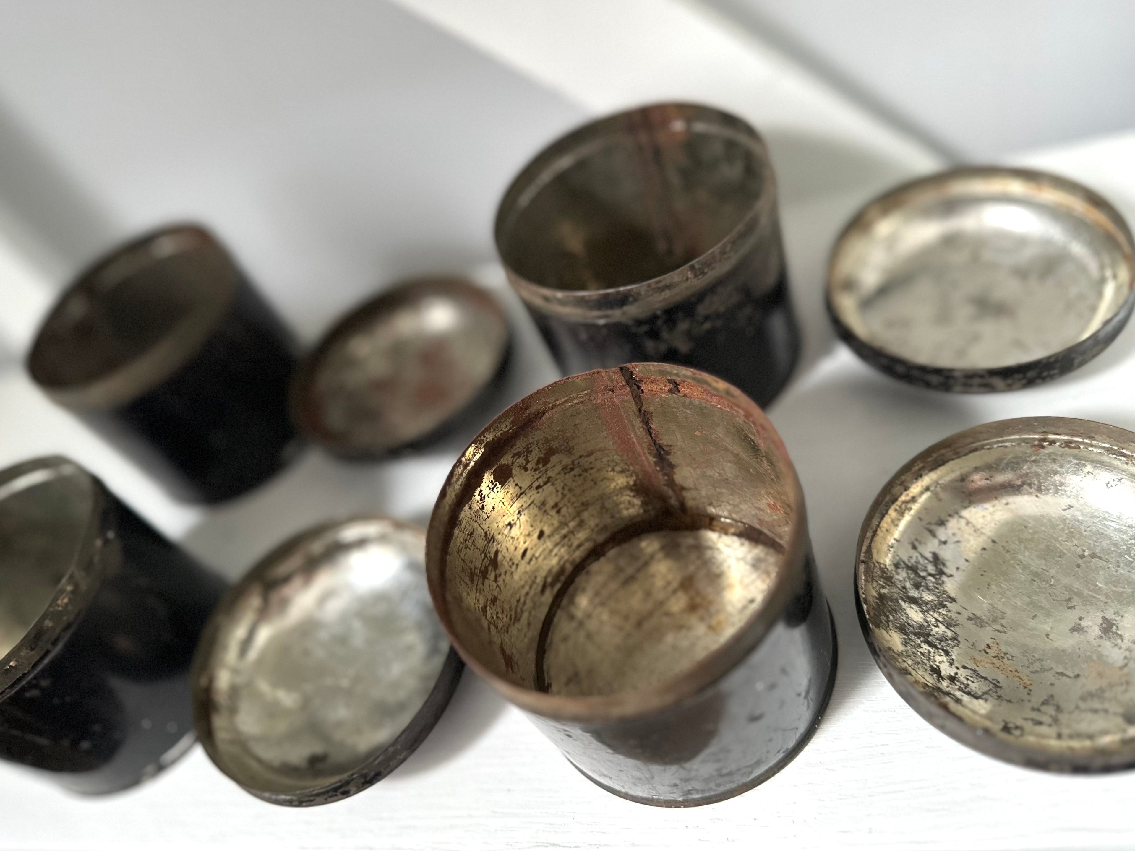 Collection of metallic buttons on a white surface