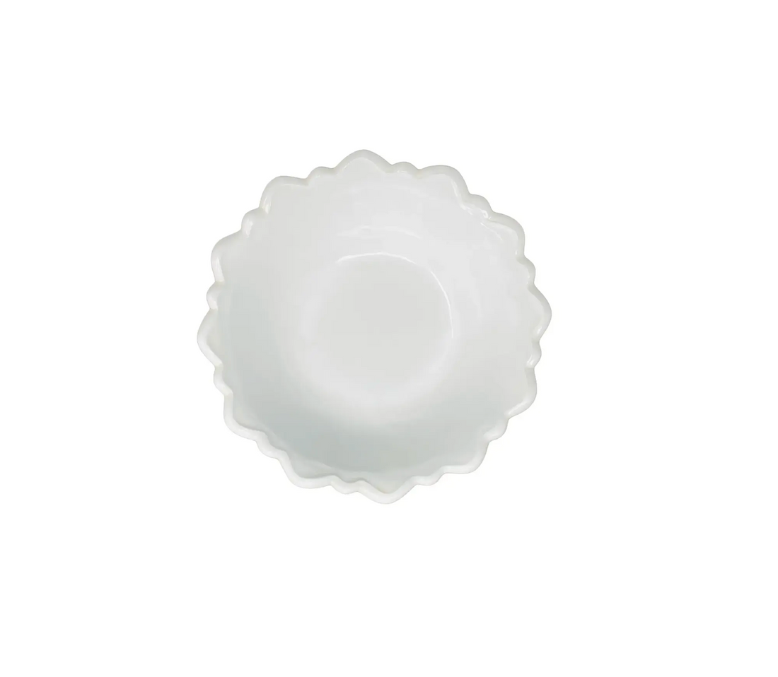 White scalloped-edge bowl on a white background
