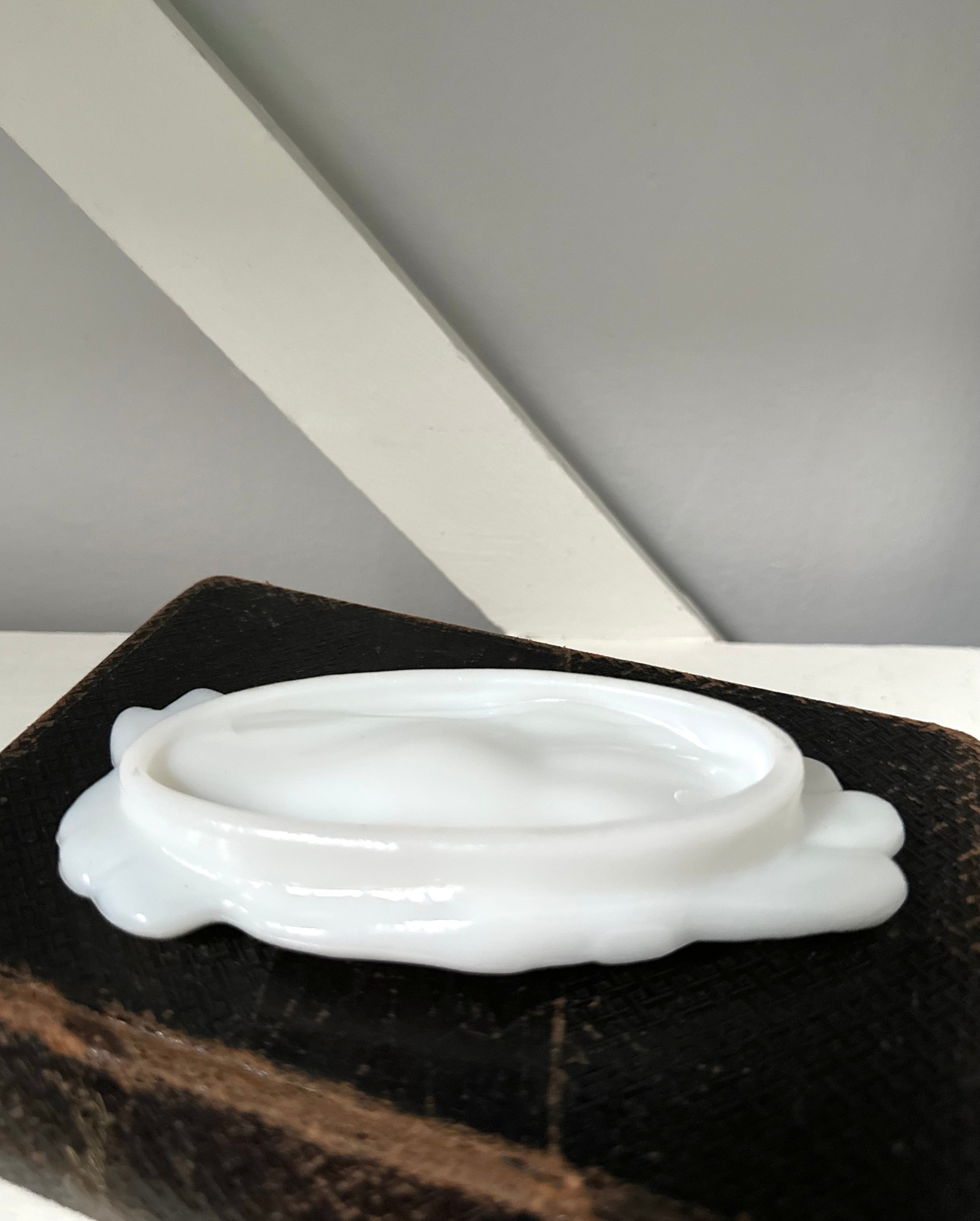 White ceramic dish on a dark brown surface with a neutral background