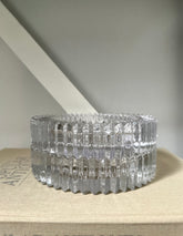 Two glass round ashtray objects sitting on a book with light background