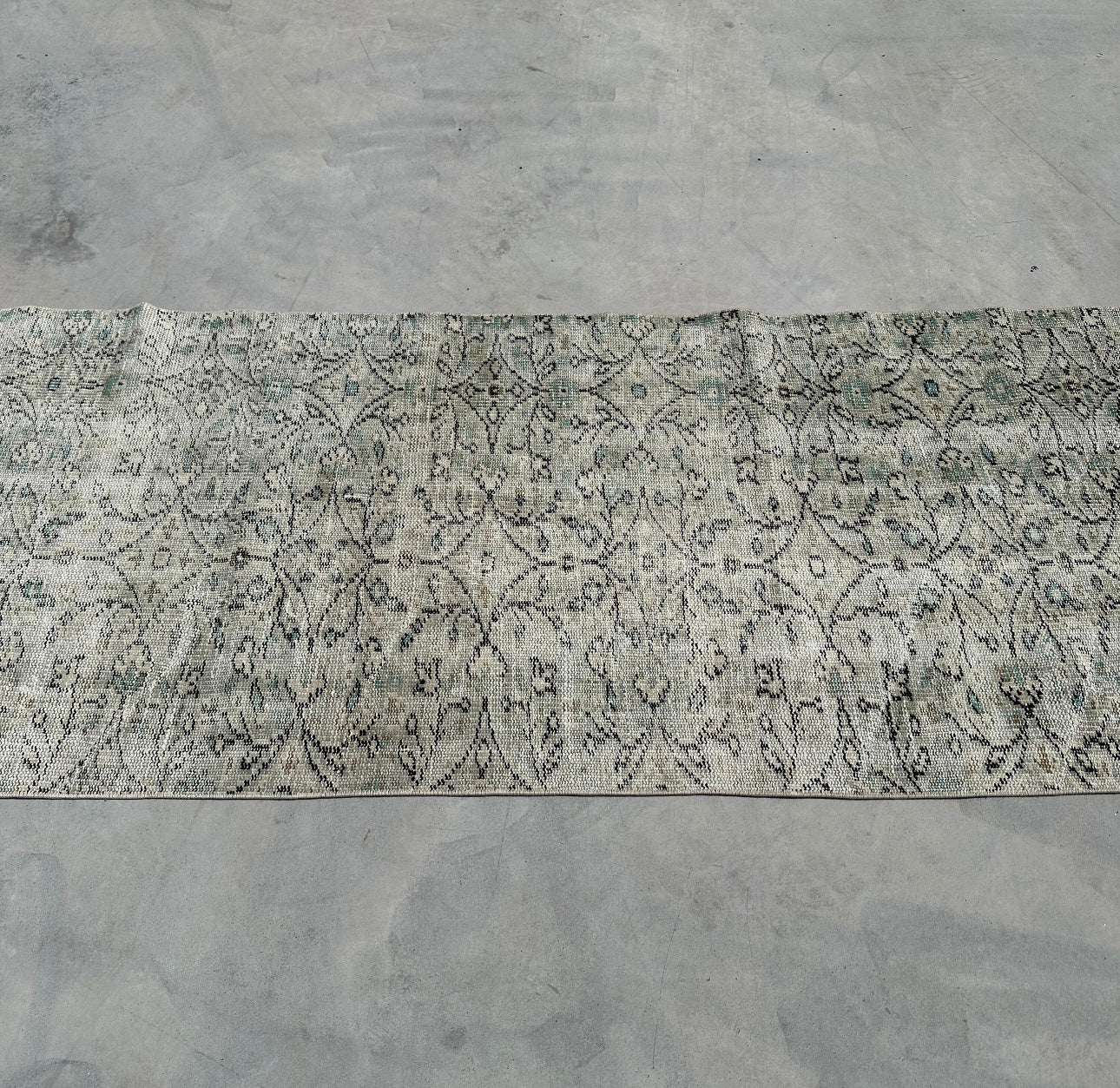 Patterned rug on a concrete floor