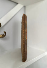 Wooden cutting board on a white shelf