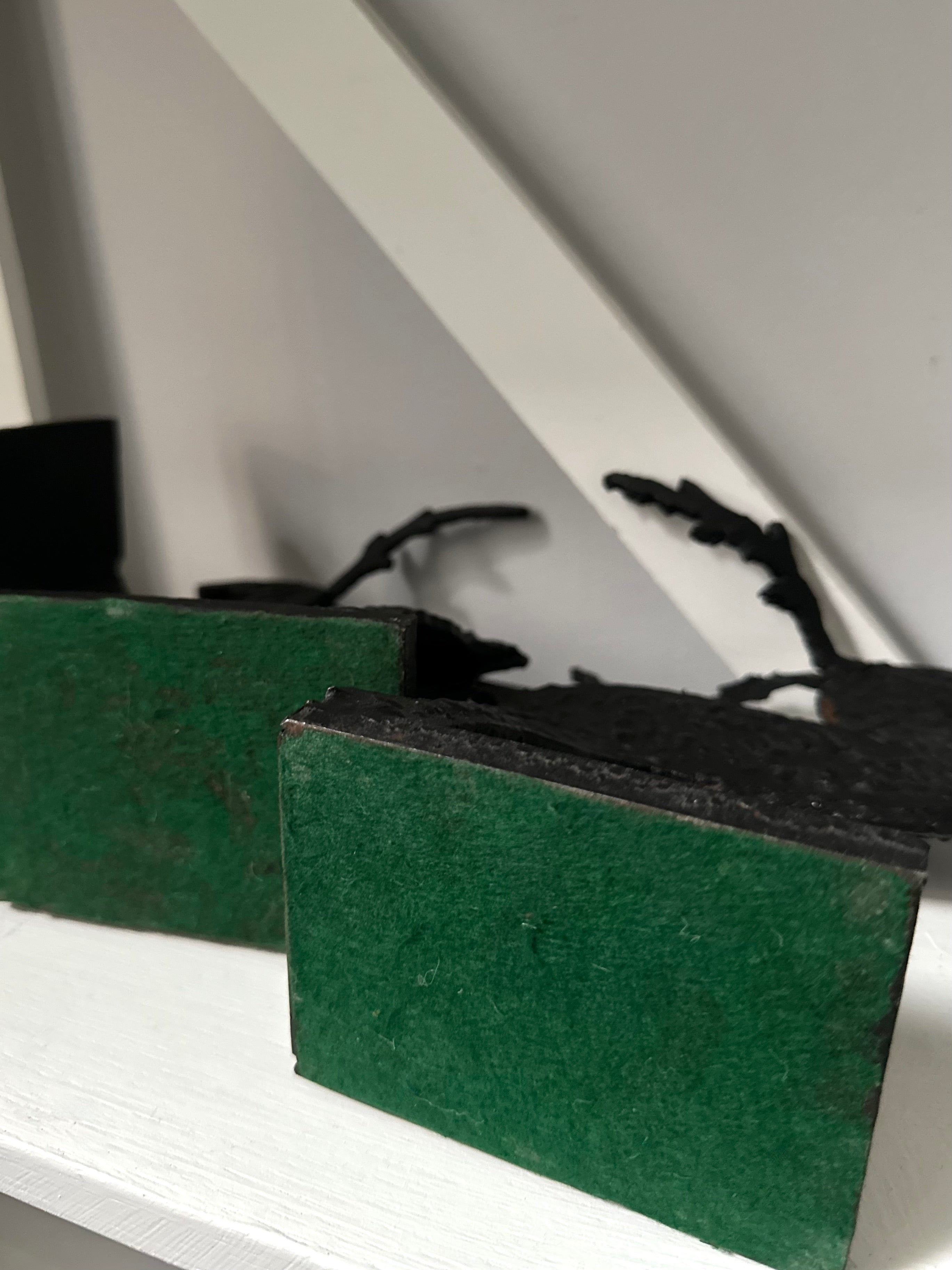 Green sponges on a white surface with a blurred background