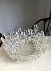 Vintage textured glass bowl sitting on a book with a light coloured background