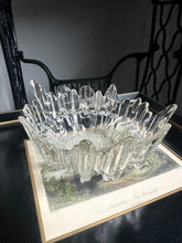 Vintage textured glass bowl sitting on a black and white print