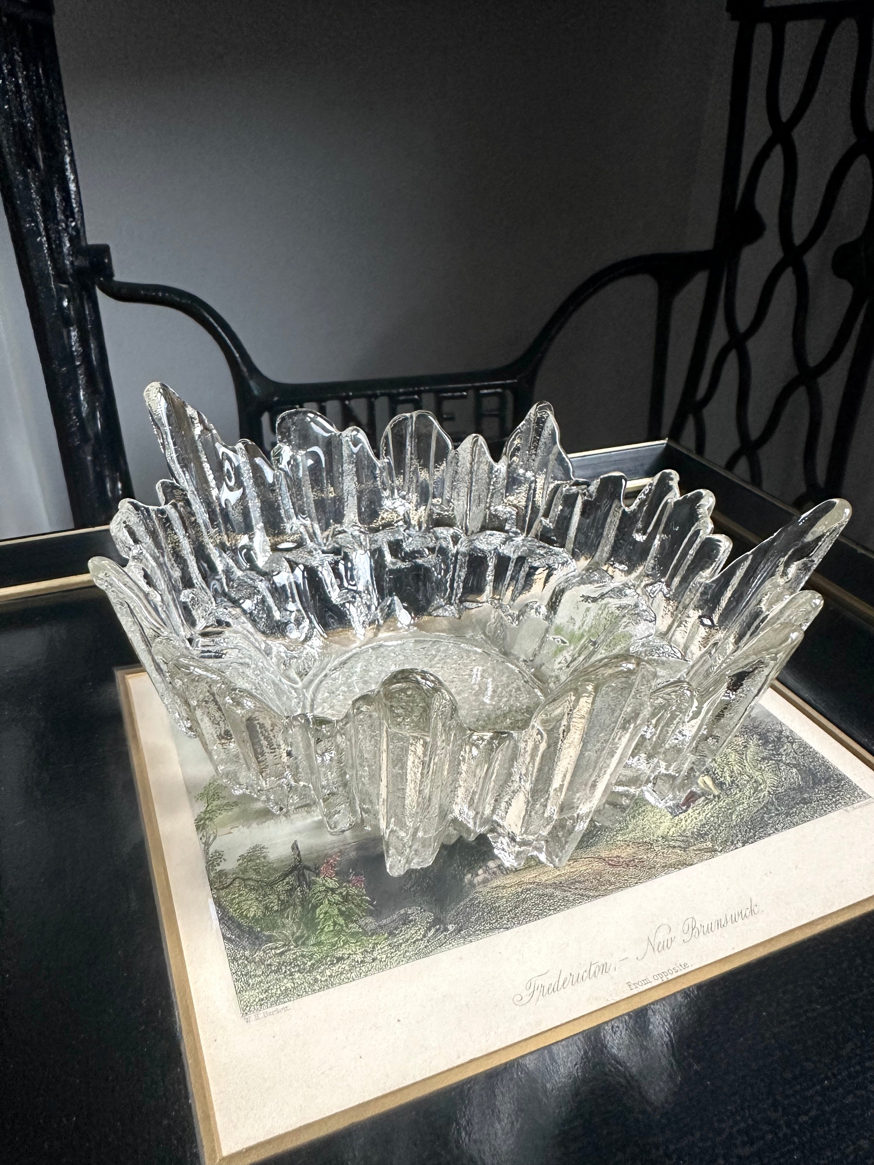 Vintage textured glass bowl sitting on a black and white print