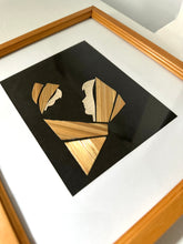 Framed artwork with geometric wooden design on black background