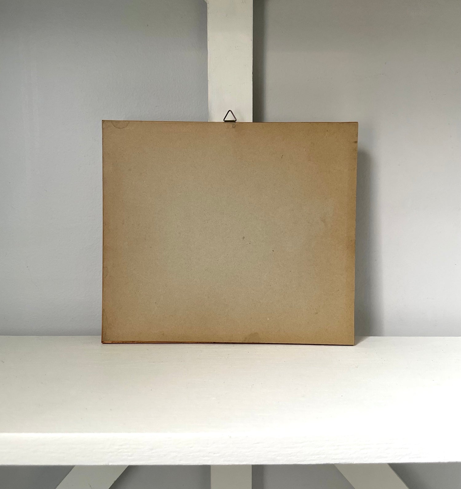 Brown cardboard box on a white surface with a gray background