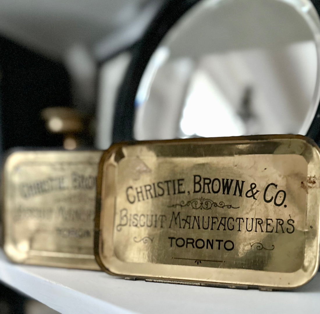 A vintage metal tin labeled "Christie, Brown & Co. Biscuit Manufacturers Toronto" on a shelf