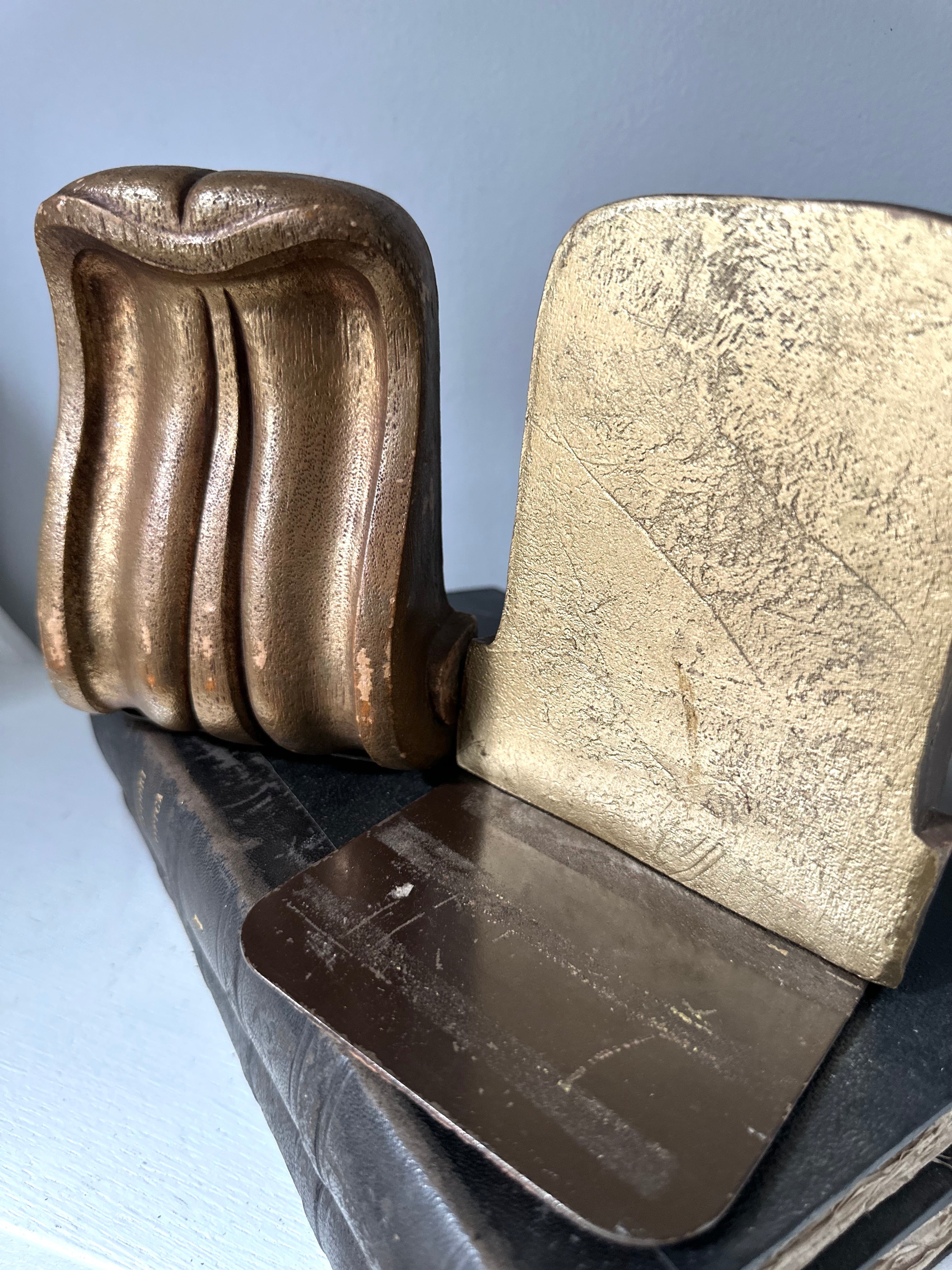 Metallic object with wavy design on a light gray background
