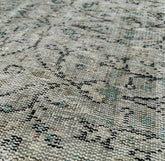 Close-up of a textured rug with a pattern of black and gray.