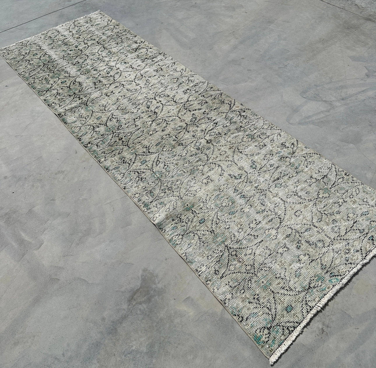 Patterned rug on a concrete floor