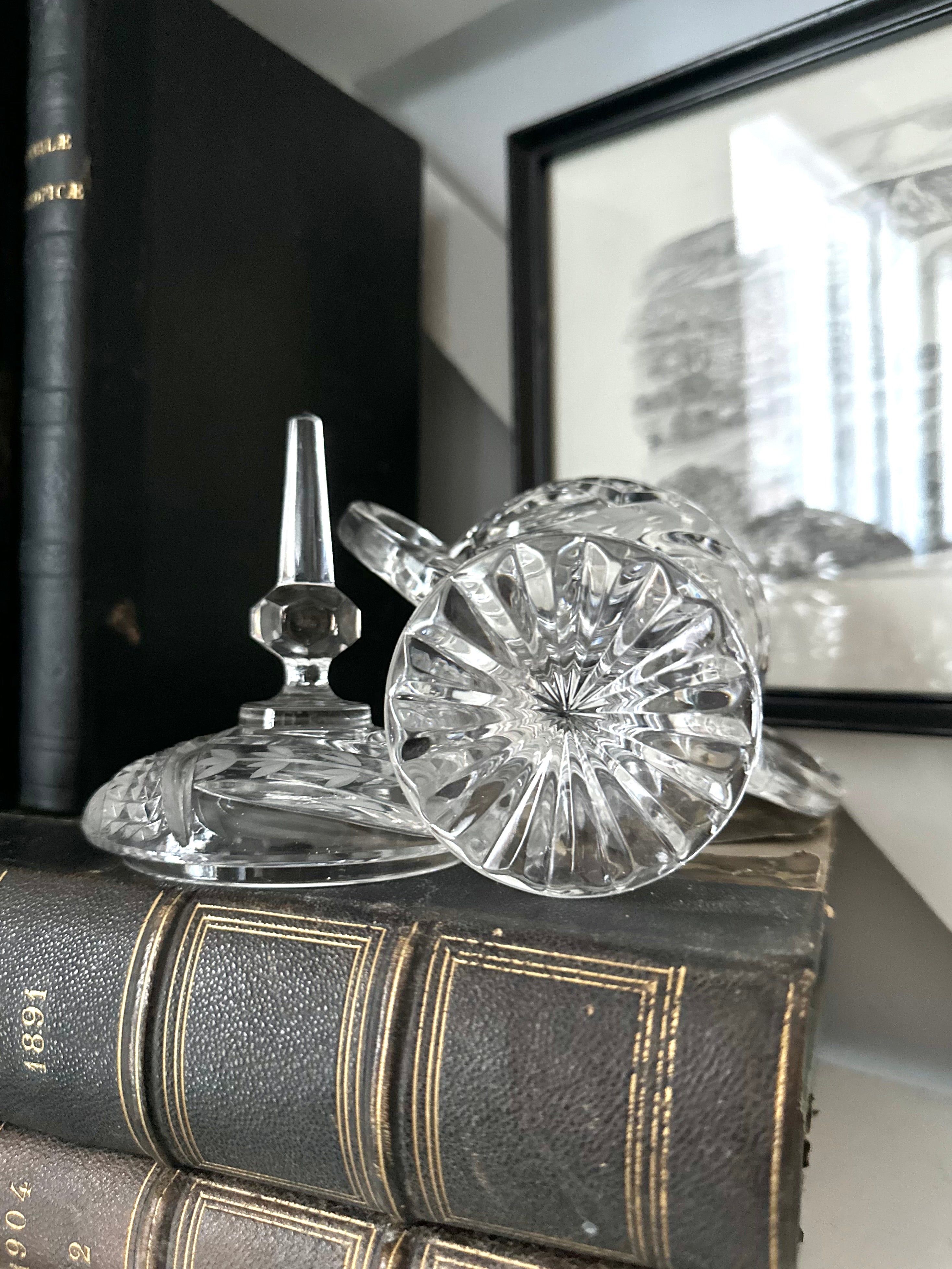 Glassware Sitting on top of Antique Books