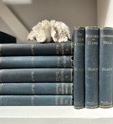 Stack of vintage books with decorative elements on a shelf