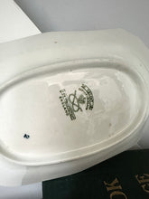 White ceramic plate with a visible brand logo on a white surface