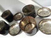 Collection of metallic buttons on a white surface