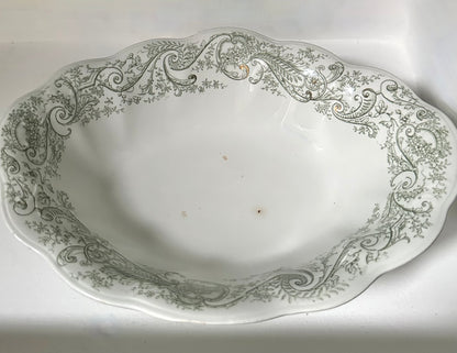 Decorative ceramic platter with intricate green patterns on a white background