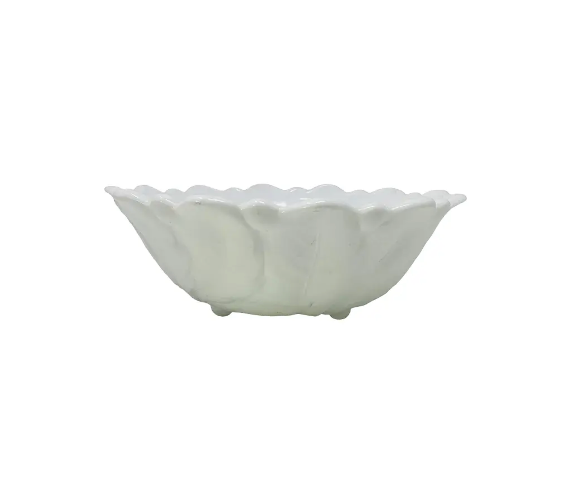 White ceramic bowl with scalloped edge on a white background