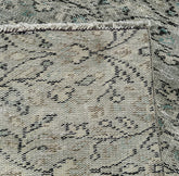 Close-up of a textured gray rug with black pattern