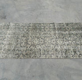 Patterned rug on a concrete floor
