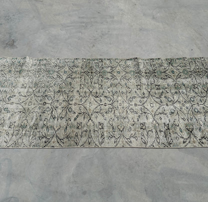 Patterned rug on a concrete floor