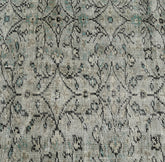 Textured fabric with intricate black pattern on a gray background