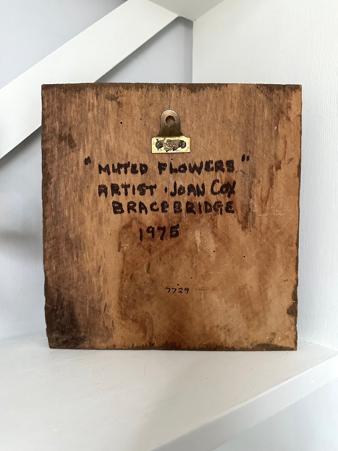 Wooden plaque with engraved text on a white background