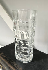 Clear glass vase with textured design on a dark surface