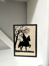Framed silhouette art of a person on a horse under a tree
