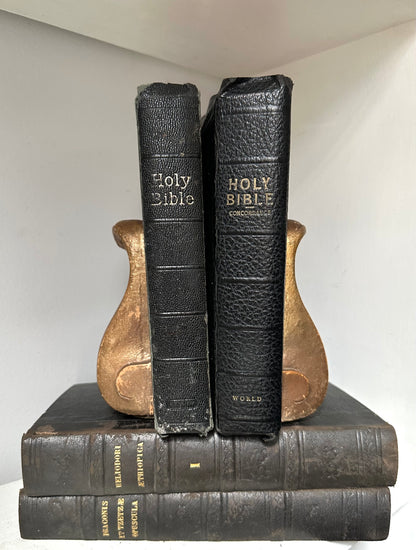 Two black leather-bound books titled &