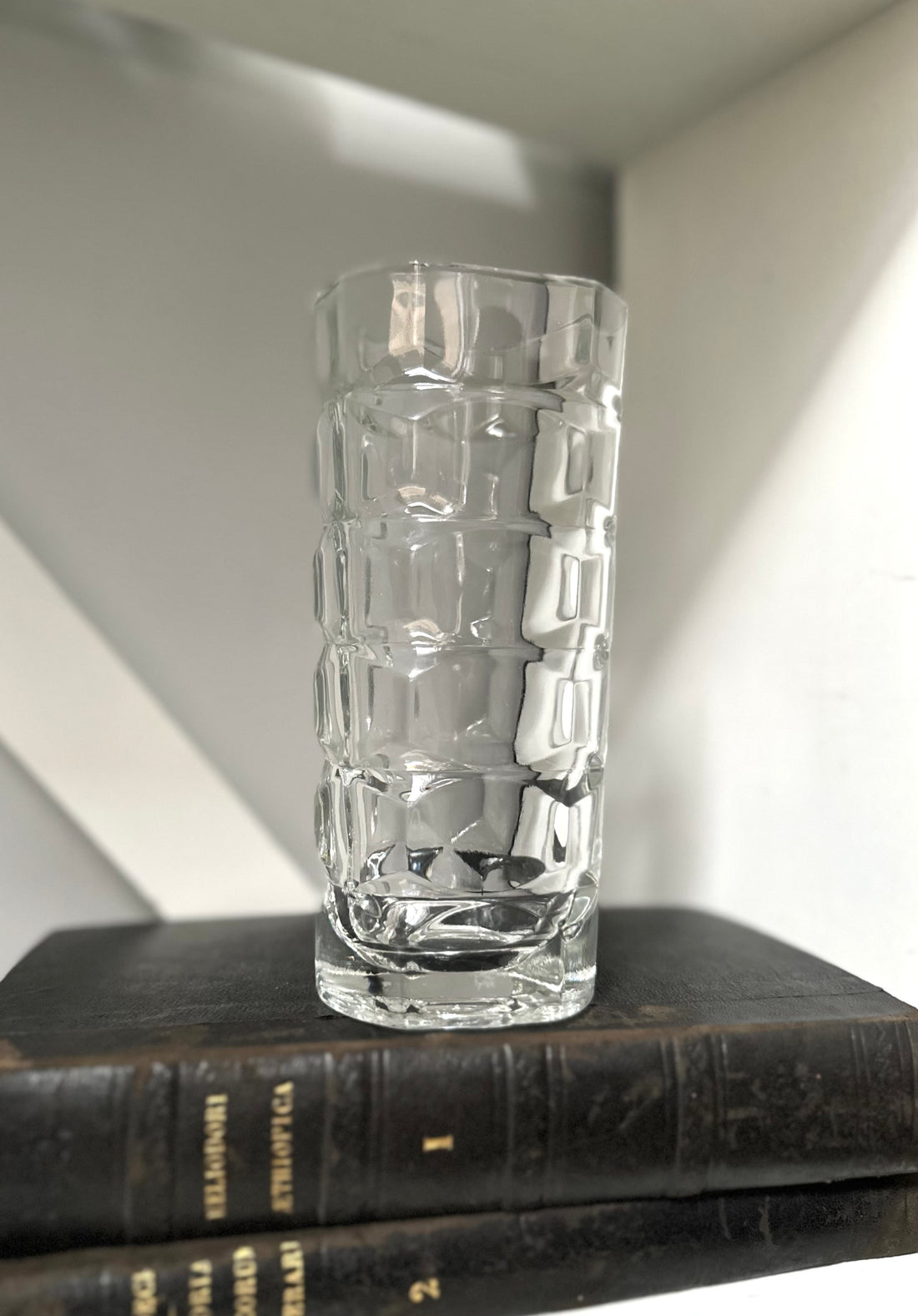 Glass Vase Stacked on Two Black Books