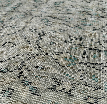 Close-up of a textured rug with a pattern of black and gray.