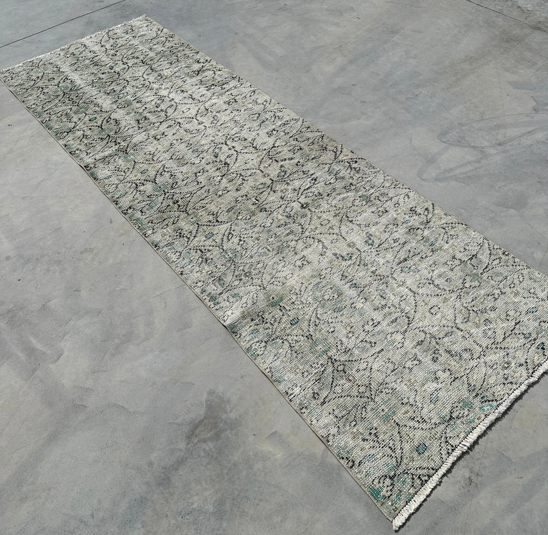Patterned rug on a concrete floor