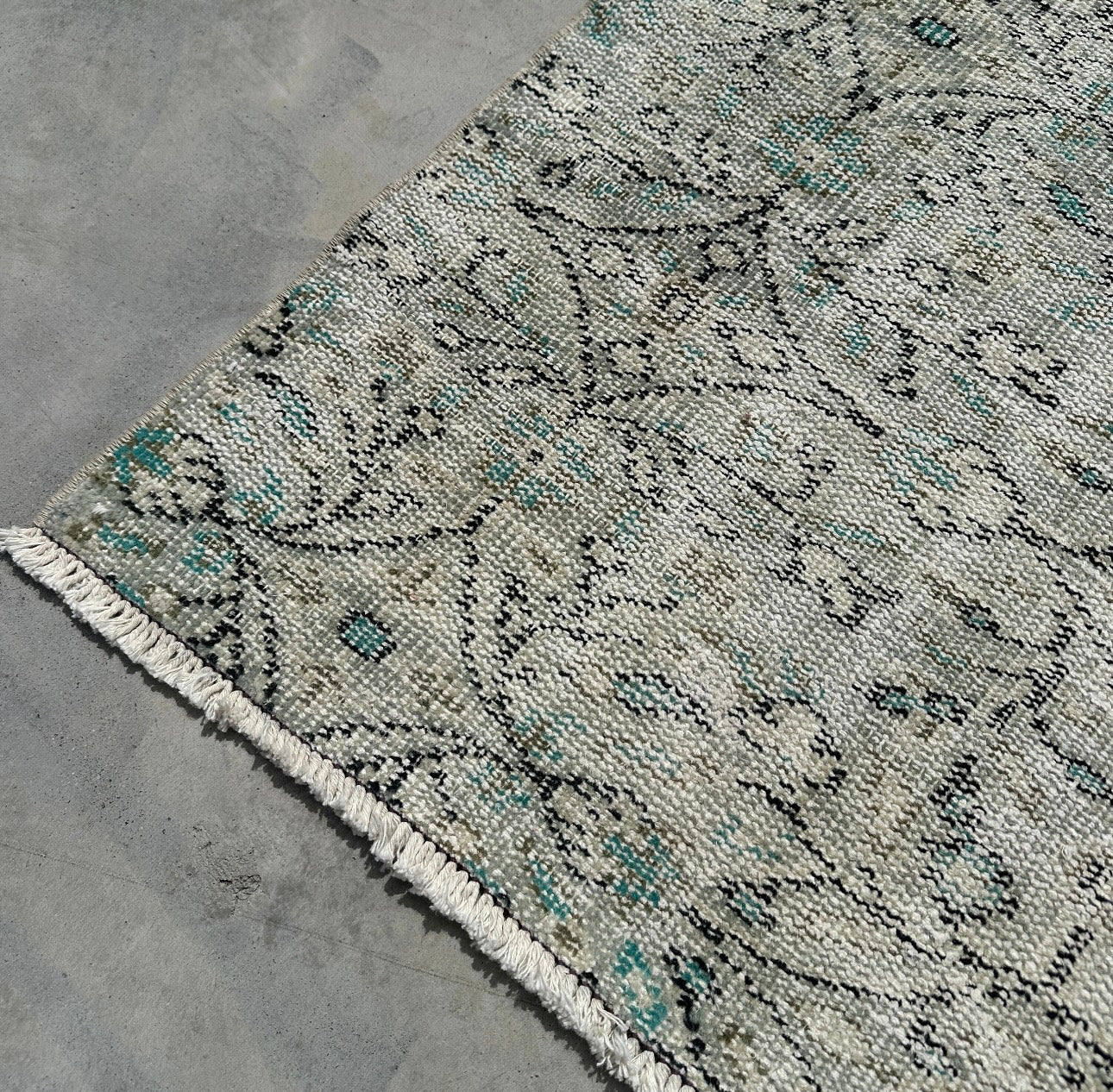 Patterned rug on a concrete floor