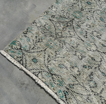 Patterned rug on a concrete floor