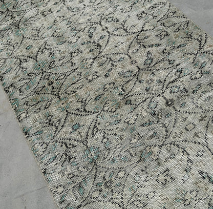 Close-up of a patterned rug on a concrete floor